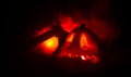 Scary orange pumpkin with carved eyes and a smile with burning candles and an ax on a dark background with fire sky. For the Hallo