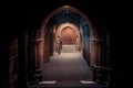 Scary pointy arcade, made of stone bricks leading to a dead end corridor dimly lit. Concept mystery and danger Royalty Free Stock Photo