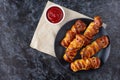 Scary sausage mummies in dough for kids party. Funny crazy Halloween food for children Royalty Free Stock Photo
