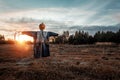 Scary scarecrow with a halloween pumpkin head in a field at sunset. Halloween background, copy space Royalty Free Stock Photo