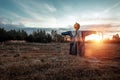 Scary scarecrow with a halloween pumpkin head in a field at sunset. Halloween background, copy space Royalty Free Stock Photo