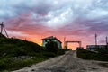 Scary and terrible sunset. Destroyed old abandoned stone house in village Teriberka in Kolsky District of Murmansk Oblast, Russia