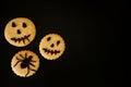 Scary and terribly tasty cookies with emoticons on a black background. Royalty Free Stock Photo