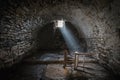 Scary underground, old dark cellar with an old abandoned chair Royalty Free Stock Photo