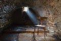 Scary underground, old dark cellar with an old abandoned chair Royalty Free Stock Photo