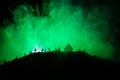 Scary view crowd of zombies on hill with spooky cloudy sky with fog and rising full moon. Silhouette group of zombie walking under