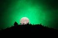 Scary view crowd of zombies on hill with spooky cloudy sky with fog and rising full moon. Silhouette group of zombie walking under Royalty Free Stock Photo