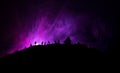 Scary view crowd of zombies on hill with spooky cloudy sky with fog and rising full moon. Silhouette group of zombie walking under