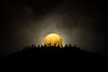 Scary view crowd of zombies on hill with spooky cloudy sky with fog and rising full moon. Silhouette group of zombie walking under Royalty Free Stock Photo