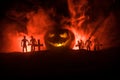 Scary view of zombies at cemetery dead tree, moon, church and spooky cloudy sky with fog, Horror Halloween concept with glowing pu