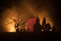 Scary view of zombies at cemetery dead tree, moon, church and spooky cloudy sky with fog, Horror Halloween concept. Royalty Free Stock Photo