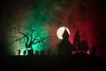 Scary view of zombies at cemetery dead tree, moon, church and spooky cloudy sky with fog, Horror Halloween concept. Royalty Free Stock Photo