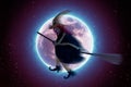 Scary witch flying on a broomstick on the background of a full moon