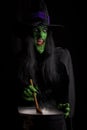 Scary witch stirring her cauldron Royalty Free Stock Photo