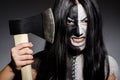 Scary woman with metal axe Royalty Free Stock Photo