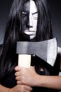 Scary woman with metal axe Royalty Free Stock Photo