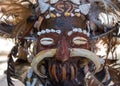 Scary wooden mask of asian totem. Head of ritual sculpture. Carnival decoration. Trible symbol. Ancient religious mask.