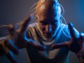 A scary young man with his head entangled in wires, uses mind control