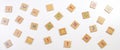 Scattered alphabet letters wooden blocks tiles on white table background. Top view