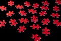 Red jigsaw puzzle pieces scattered on black background problem solving concept created with ai. Royalty Free Stock Photo