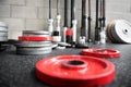 Scattered barbell weights on the floor of a gym