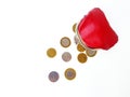 Scattered Belarusian coins from a red leather purse on a white background. Royalty Free Stock Photo