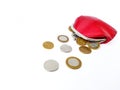 Scattered Belarusian coins from a red leather purse on a white background. Royalty Free Stock Photo