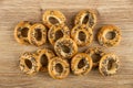 Scattered bread rings with poppy on wooden table. Top view Royalty Free Stock Photo