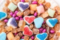Scattered candy and sugar sweets in the shape of heart, cute tasty jelly beans
