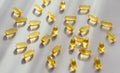 scattered capsules of omega 3 fish oil on a light background Royalty Free Stock Photo