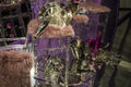 The scattered chairs and glasses, champagne bottles. Exposition. Decorative show-window. Pink colors. Unusual decision. Chaos.