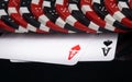 Scattered chips, for playing in the casino, on two aces, on the black surface of the mirror table Royalty Free Stock Photo