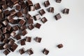 Scattered chocolate squares on a white background,. Generative Ai