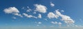 Scattered clouds across blue panoramic sky