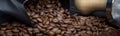 Scattered coffee beans on a black background. Close-up. Panorama format Royalty Free Stock Photo