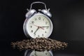 Scattered coffee beans, classic alarm clock. Morning coffee day start. Concept for advertising. Time to drink coffee Royalty Free Stock Photo