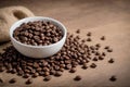 Scattered Coffee Beans. White cup and coffee beans. Shallow depth of field. White background. Royalty Free Stock Photo