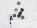 Scattered coins from pocket of white shirt Royalty Free Stock Photo