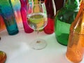 assorted shapes, sizes, and color bottles.. rainbow with clear wine glass