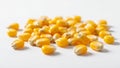 Collection of yellow corn kernels is set against a plain white Royalty Free Stock Photo