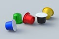 Scattered colorful coffee capsules on gray background. Modern decaf pods for machine.