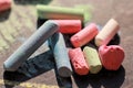 Scattered colorful crayon chalks on black boar Royalty Free Stock Photo