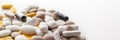 Scattered colorful pills on a white background. Copy space. Royalty Free Stock Photo