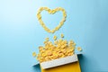 Scattered cornflakes out of box a heart shaped. Dry cereal breakfast. I love cereal. Royalty Free Stock Photo