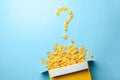 Scattered cornflakes out of the box in the shape of a question mark. Dry cereal breakfast Royalty Free Stock Photo