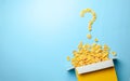 Scattered cornflakes out of the box in the shape of a question mark. Dry cereal breakfast. Copy space for text. Royalty Free Stock Photo