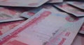Scattered Dirham Banknote Pile