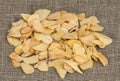 Scattered dried garlic on a background of rough cloth