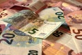 Scattered euro banknotes in denominations of five euros, ten euros, twenty euros, fifty euros, mixed banknotes as background