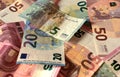 Scattered euro banknotes in denominations of five euros, ten euros, twenty euros, fifty euros, mixed banknotes as background